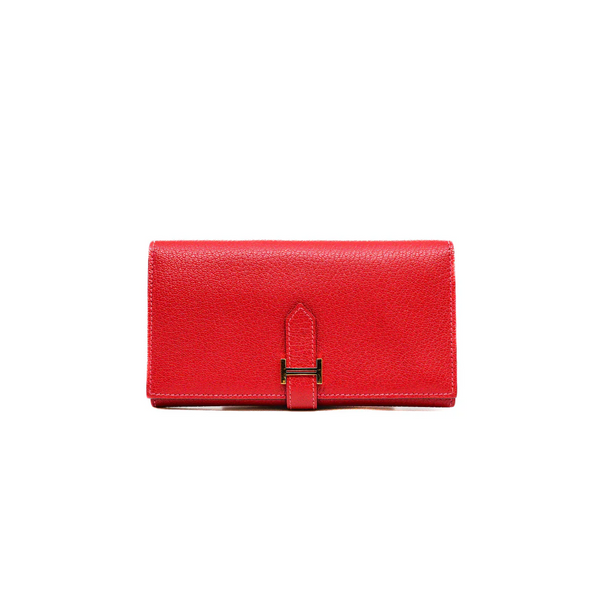 A red leather wallet featuring a branded logo for a stylish and practical accessory