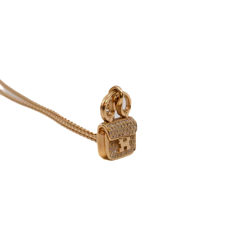 Amulettes Constance pendant rose gold set with diamonds and Kelly snap closure